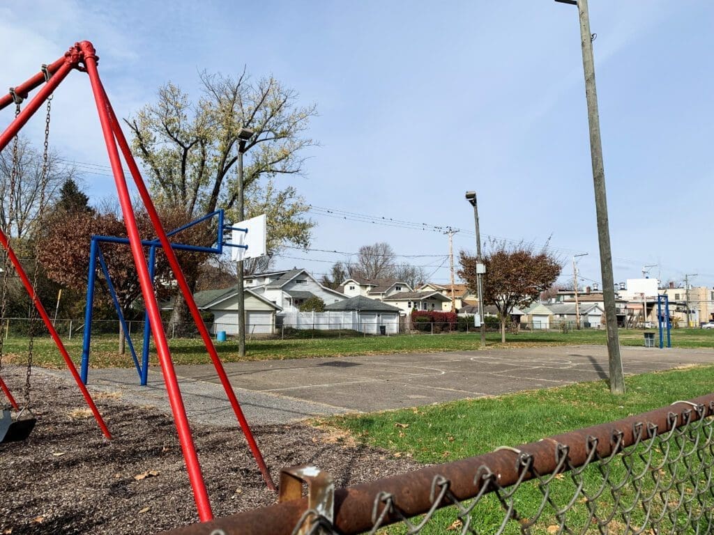 An asphalt basketball court.