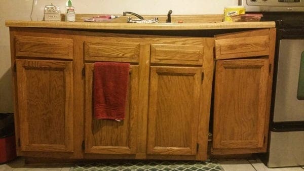 A kitchen cabinet system that is obviously in bad shape.