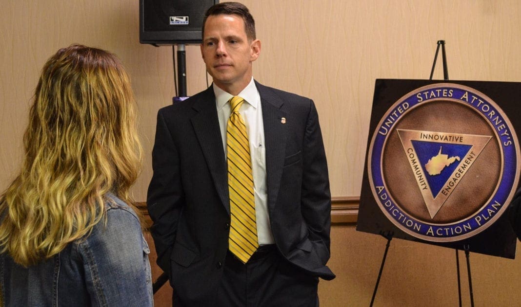 A photo of a man speaking with a young lady.