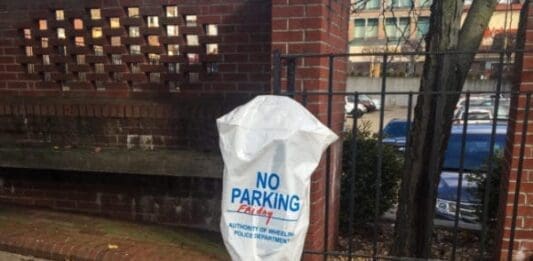 A parking metter that has been bagged by law enforcement.