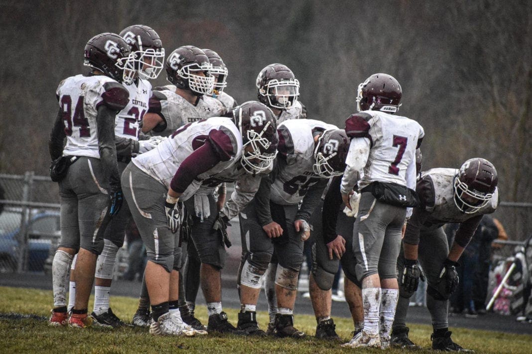 A photo of a high sport football team in a huddle.