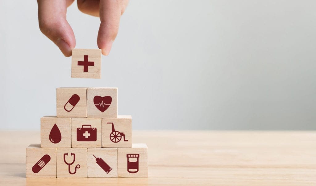 The stacking of play block that feature health care symbols.