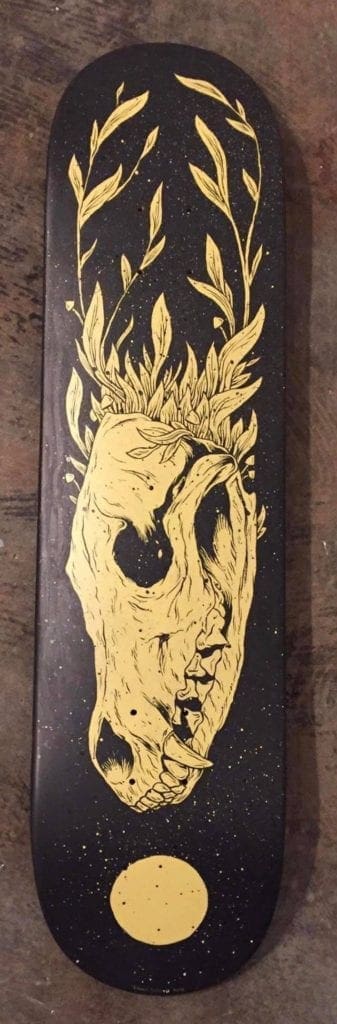 This skateboard deck features an animal skeleton.