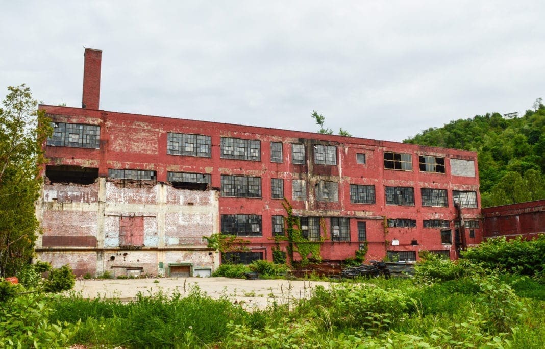 A photo of an old brick factory along a creek.