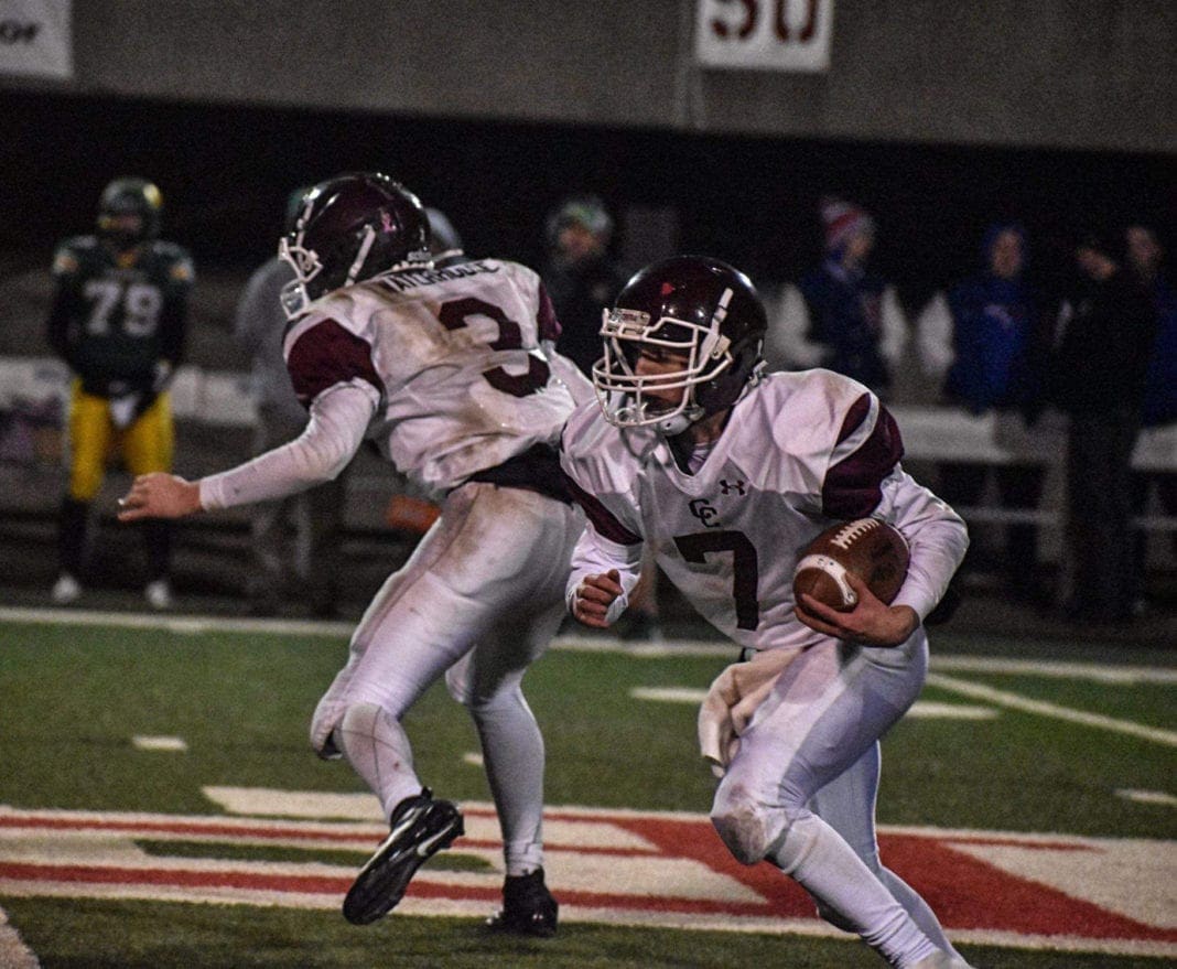 A photo that shows a quarterback rushing.