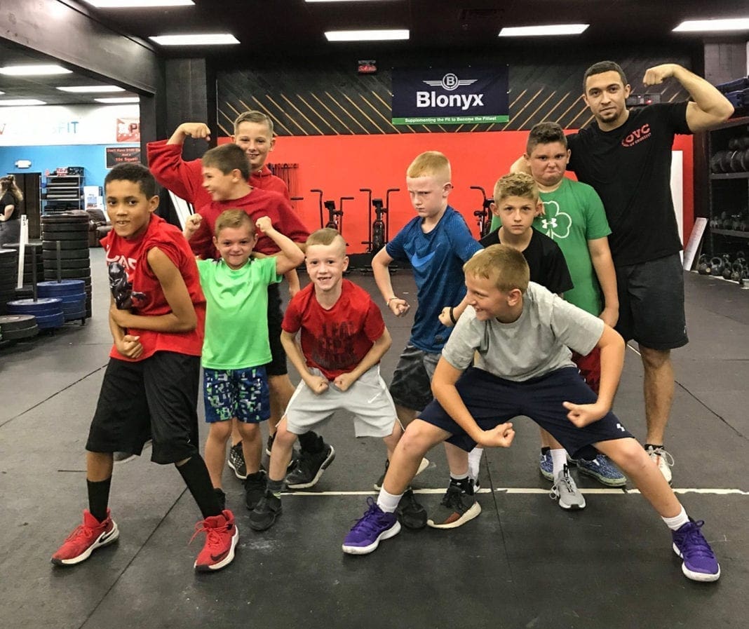 A group of young athletes flexing their muscles.