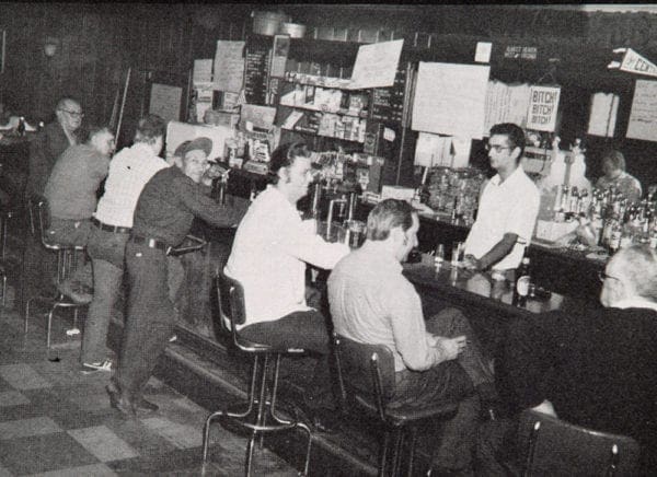 A group on men sitting at a bar.