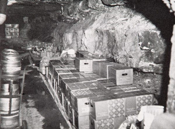 A natural cave with cases of beer in it.