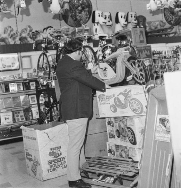 This black-and-white photo show a toy department.