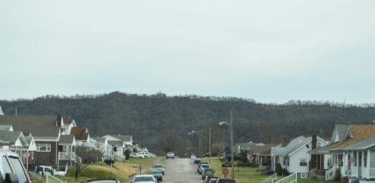 A photo of a street full of houses.