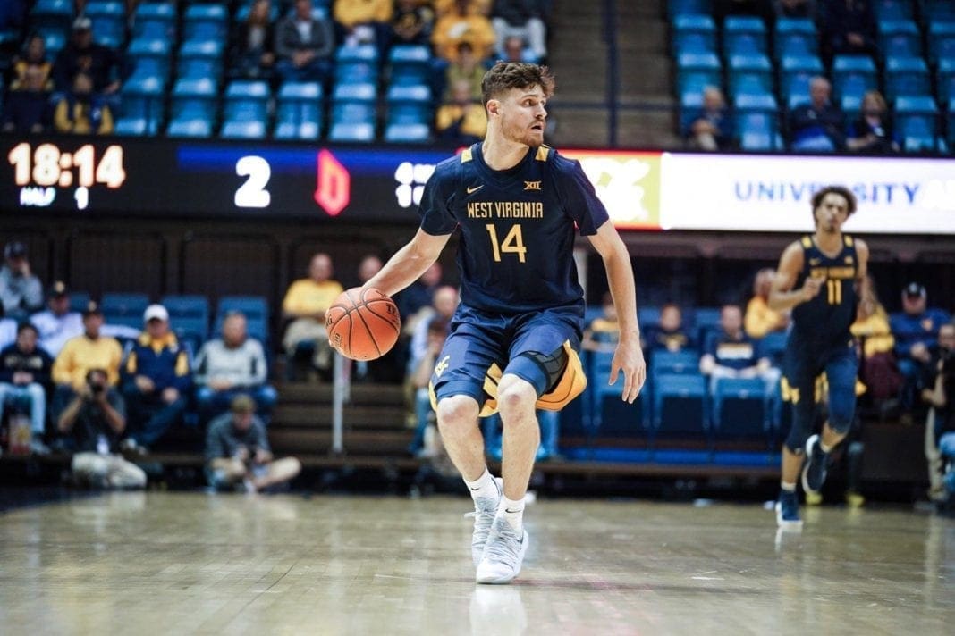 A photo of a basketball player dribbling.