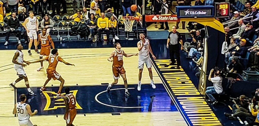 A basketball players near the basket.