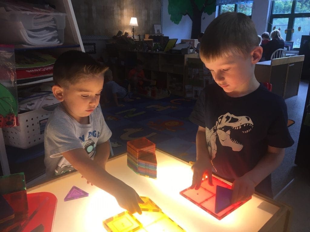 Young students using a light board.