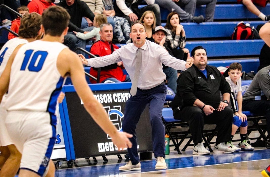 A basketball coach reacts to a bad call.