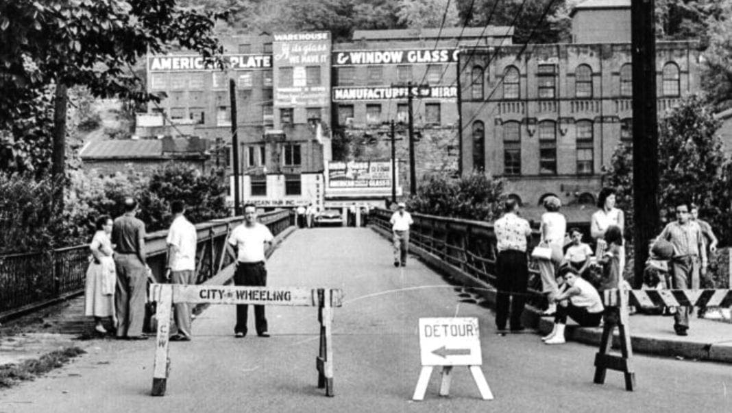 A black and white photo of a bridge.