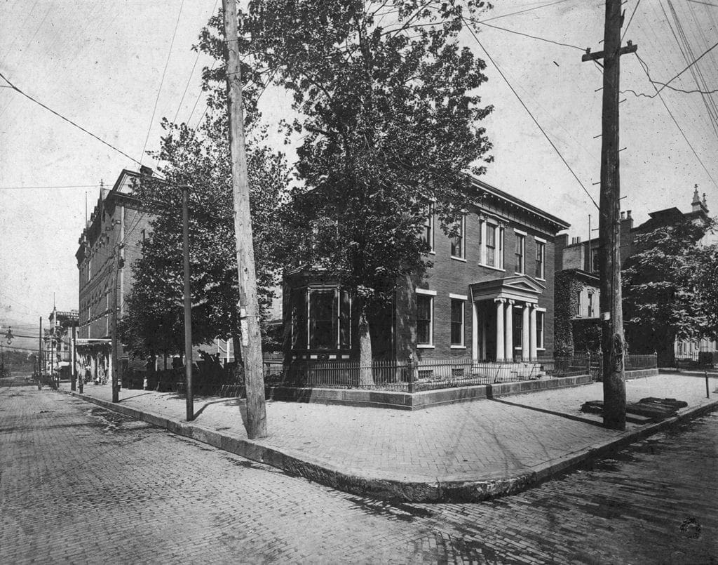 A historic photo of a small house.