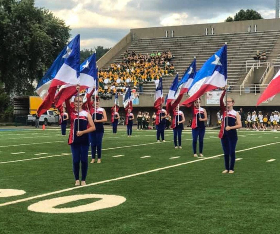 A photo of a high school flag corps.