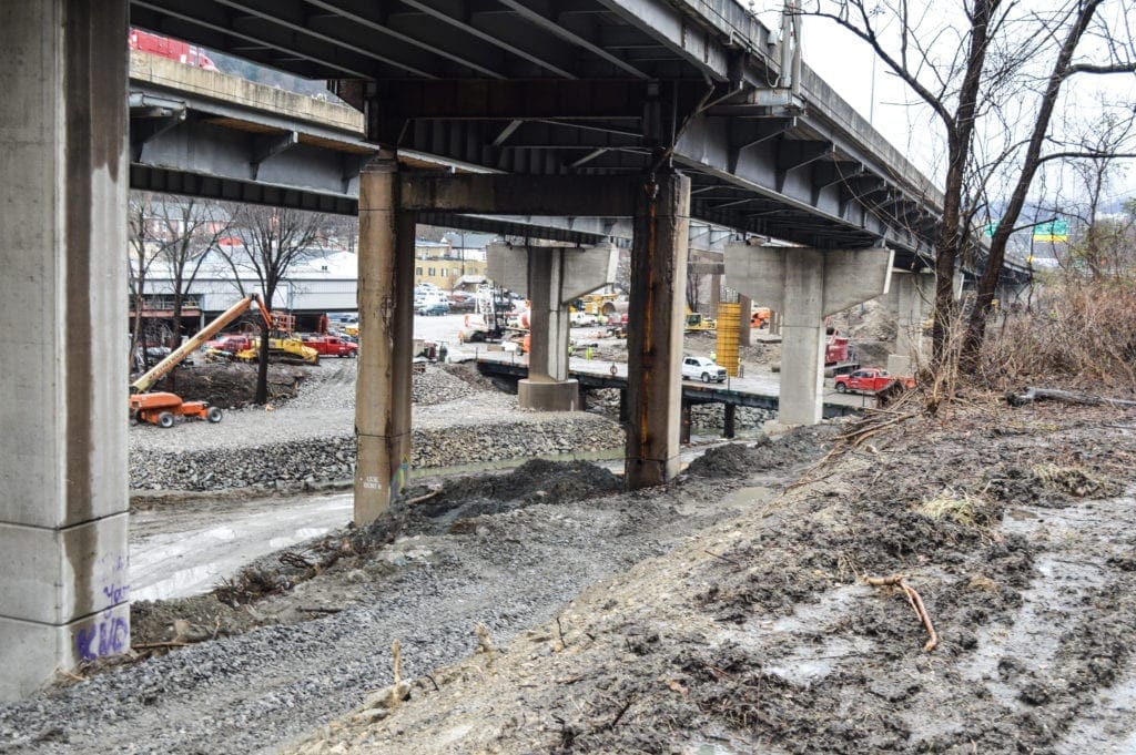 A muddy area under an interstate.