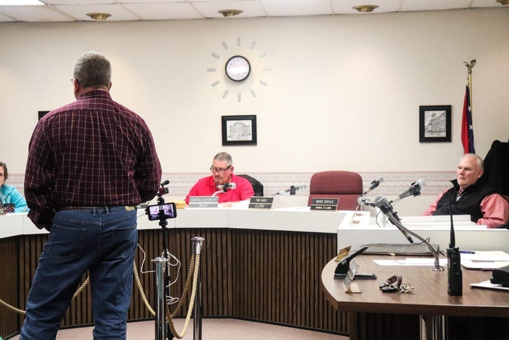 A man addressing members of a council.