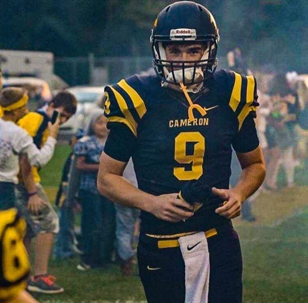 A photo fo a football player running on a field.