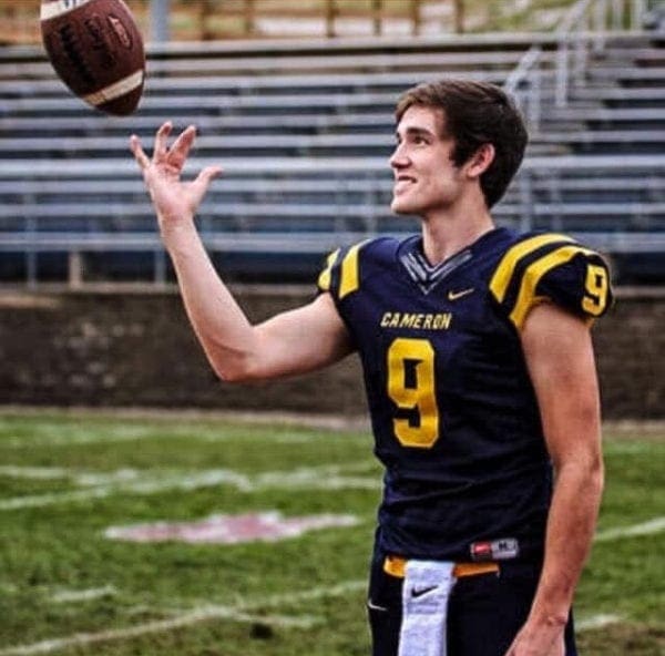 A photo of a young man with a football.