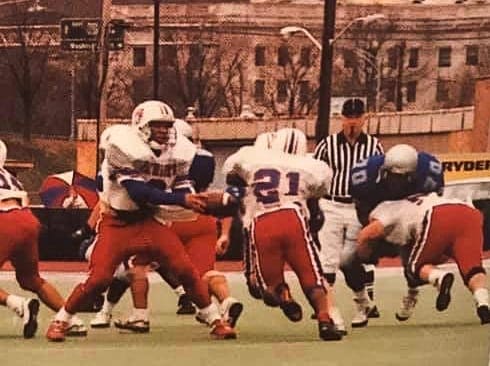 An older photo of a high school football game.