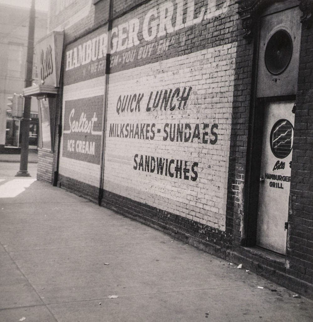 A painted ad on a building wall.