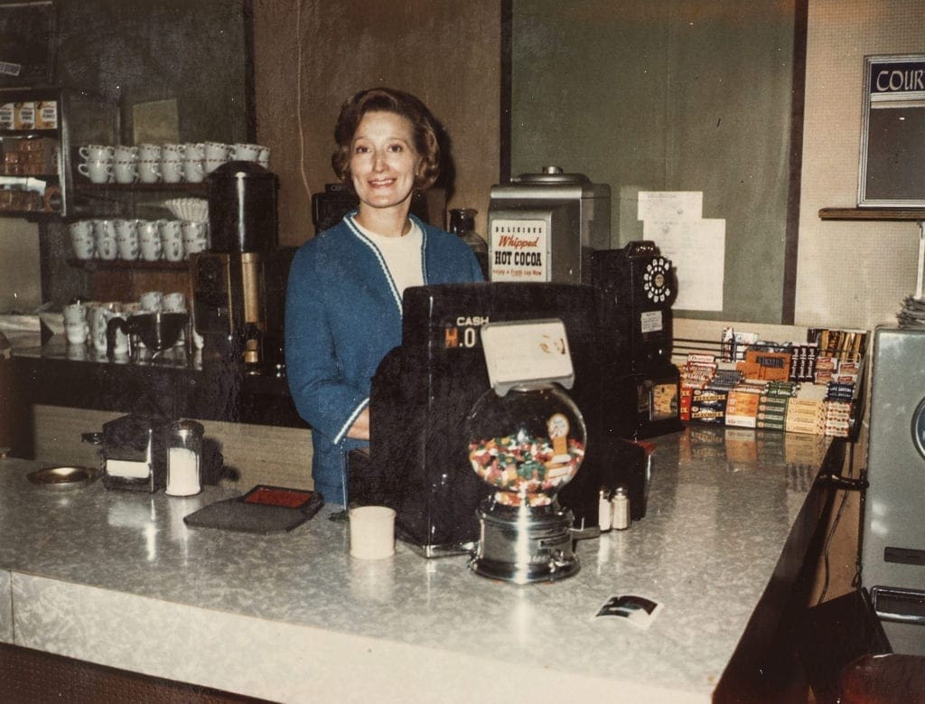 A female cashier at the counter.