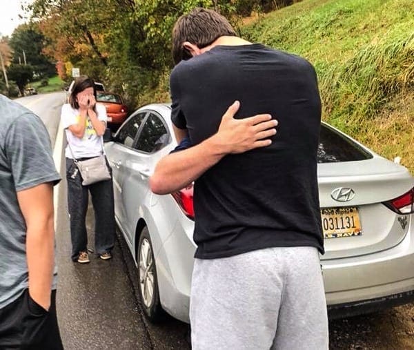 Two young men embracing.