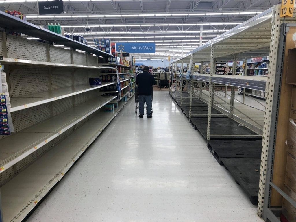 A photo of empty shelves at a Walmart.