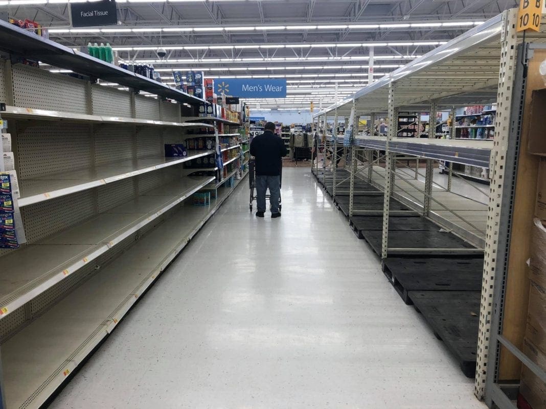 A photo of empty shelves at a Walmart.