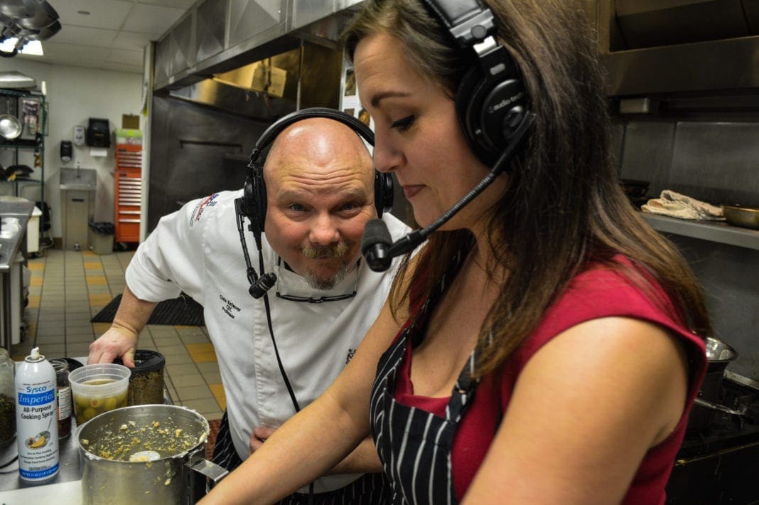 A chef and a co-host in a kitchen.