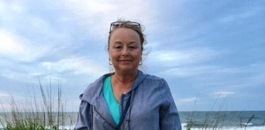 A photo of a lady at the beach.