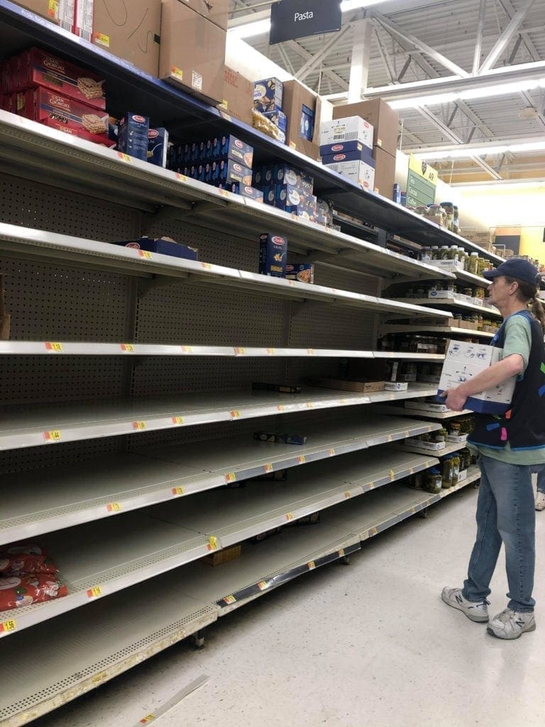 An employee putting the last products on the shelf.