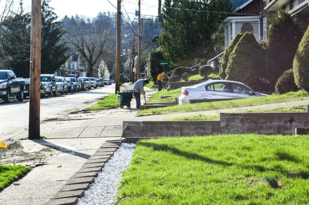 A couple of neighbors scrapping mud off of driveways.