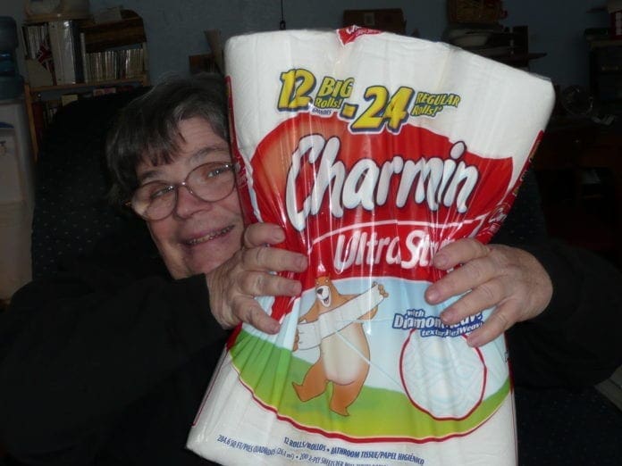 A photo of a lady squeezing Charmin.
