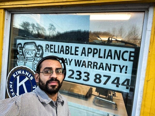 Alex Coogan in front of Reliable Appliance