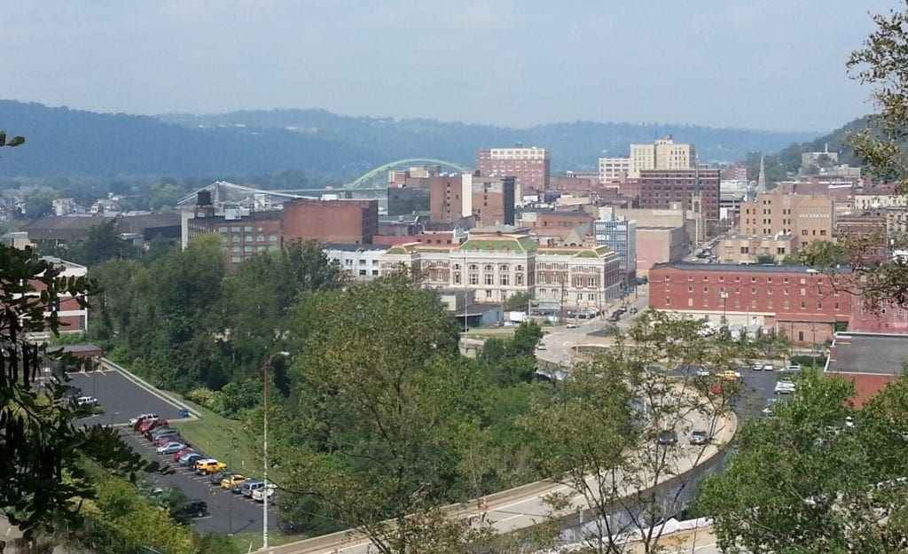 A view of a downtown district from a hilltop.