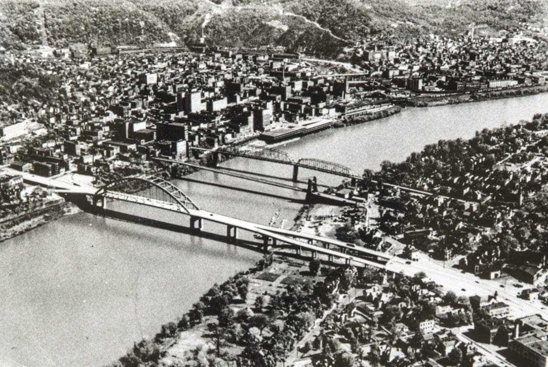 A bird's eye view of three bridges spanning a river.