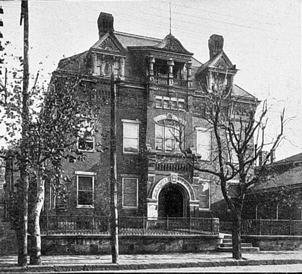 A black and white photo of a large house.