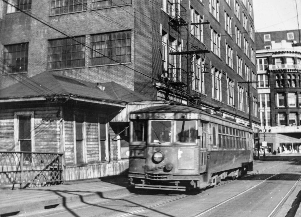 A photo fo a trolley crossing a bridge.