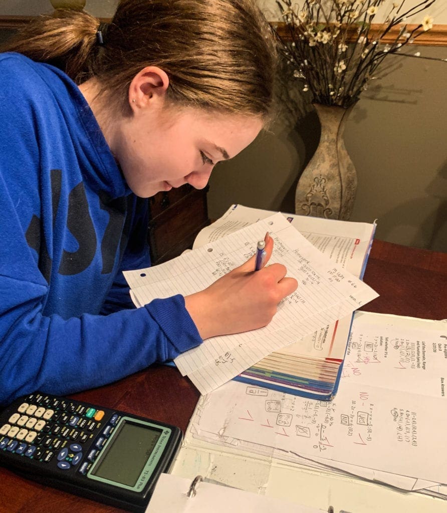 A young female student working on math problems.