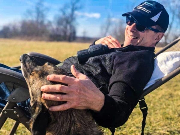 A man relaxing with his dog.