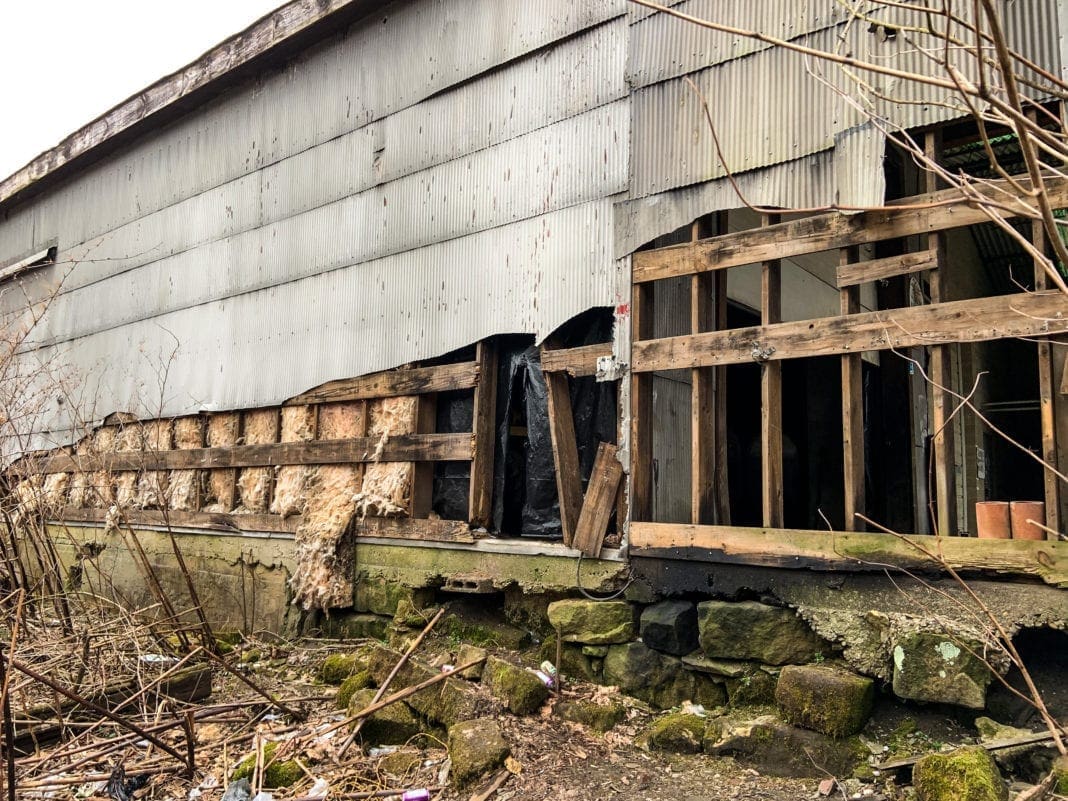 A warehouse where tiling has bee ripped off.