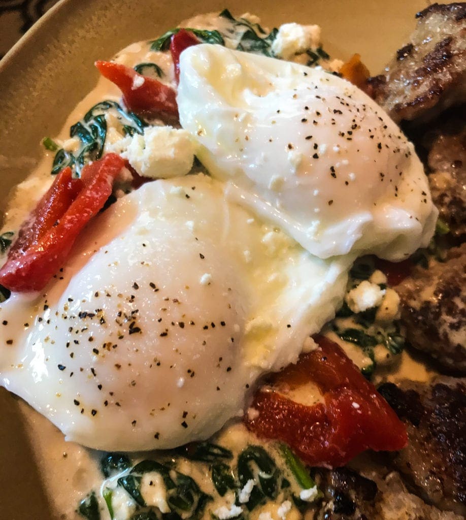 A photo of eggs on spinach.