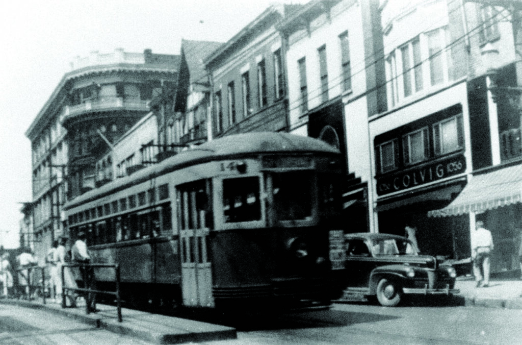 A trolly in a downtown.