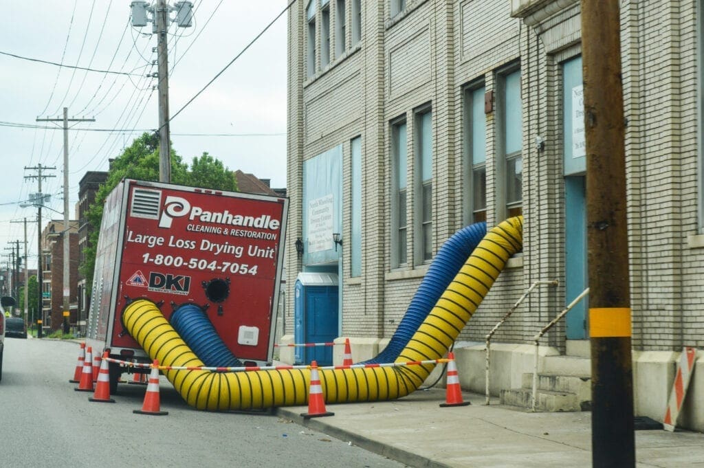 A photo of a restoration company has dryers in the windows.