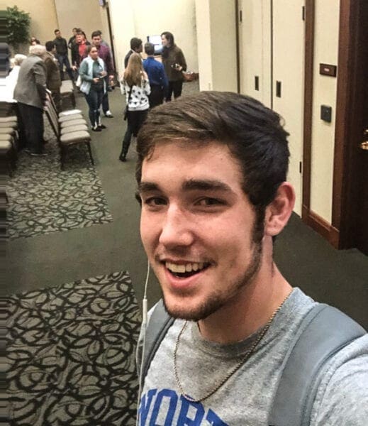 A young man in a college building.