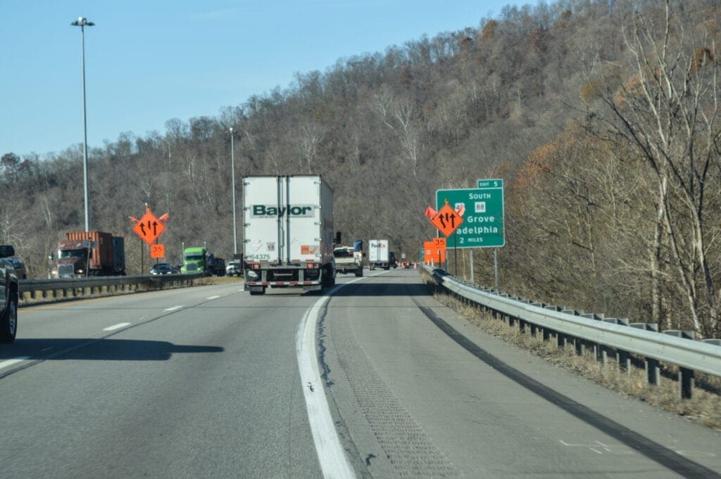 An interstate with a lot of orange signs.