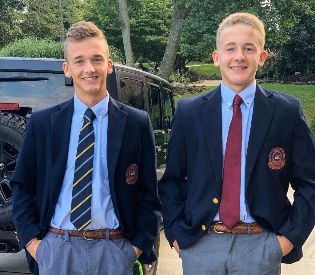 Two sons wearing ties and blazers.